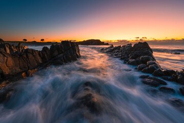 Beautiful wave flow on the rocky coastline of Crescent Head, NSW, Australia.