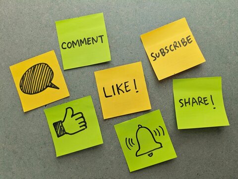 Social Media Engagement Colorful Sticky Notes with HandDrawn Icons on Textured Gray Background.