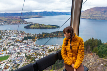A girl enjoys a ride on Skyline Queenstown Gondola, the steepest cable car in the Southern...