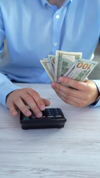 The director's assistant counts money and cash on a calculator.
A bank employee calculates his salary on a calculator.
Calculate money using a calculator.
Businessman counts profit from deal