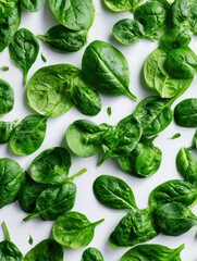 Fresh Spinach Leaves Scattered Like Feathers With Untouched Area in the Upper Section on a Clean Surface