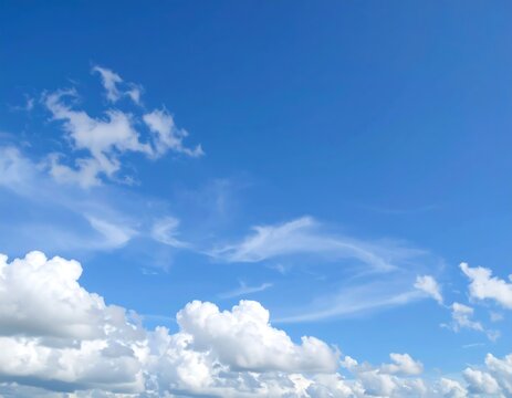 Clear blue sky with fluffy clouds