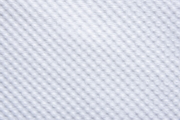  close-up of a white woven fabric, showcasing its delicate, uniform texture and subtle shadows.