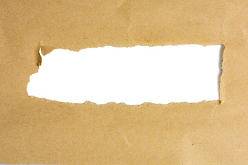 The Photograph of a brown, rough paper that has been torn open.