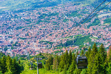 Aerial view of Sarajevo and Cable Car arriving at the top of the Mount Trebevic , Bosnia and...