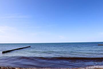 Tranquil waves roll onto the Baltic Sea shore under a wide open sky — a peaceful moment by the...