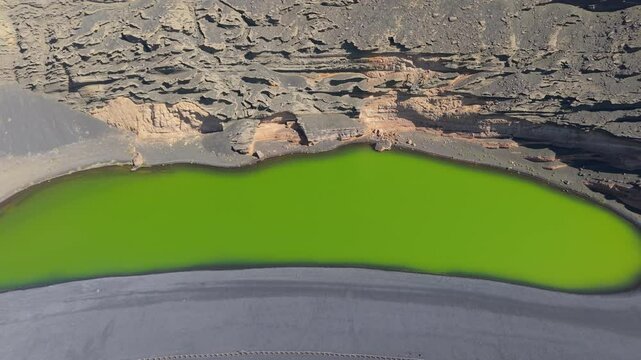 Aerial views over the green waters of the Charco de los Clicos, also known as Lago Verde, in Lanzarote, Canary Islands
