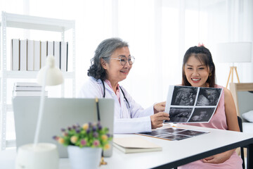 An expectant mother visits the clinic for prenatal care, a professional obstetrician. With...