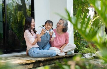 A multigenerational family gathers at home, sharing love and happiness in a heartfelt portrait. The...