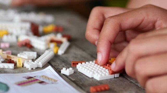 Children hands play with colorful blocks