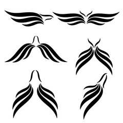 Set of black silhouettes of wings on a white background.