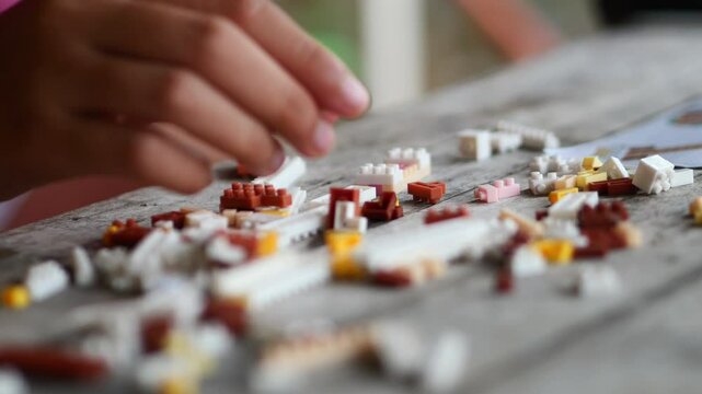 Children hands play with colorful lego blocks 