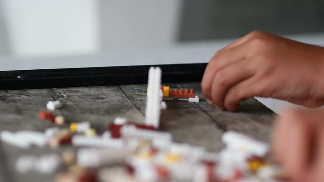Children hands play with colorful lego blocks 