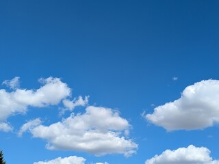Blue sky with strong big white fluffy clouds