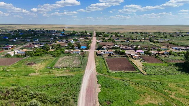 Drone, village, landscape, field &mdash; aerial view of Borisovka village in Kazakhstan with scattered rural houses, sunny day, farmland plots and lush green meadows. Quiet countryside scenery