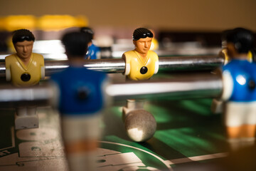 Football table players with the ball close up.