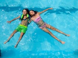 happy family jumping in pool