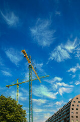 A bright construction cranes , symbolizing urban development, innovation and modern architecture.