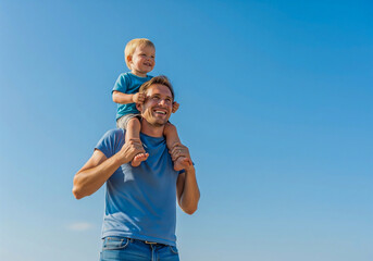 Fototapeta premium Happy Father and Son Playing on Shoulders Outdoors – Parenthood, Childhood Joy & Family Bonding