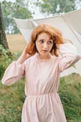 Red-haired Woman in Pink Dress Outdoors with Linen Background