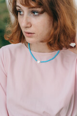 Young Woman Wearing Turquoise Beaded Necklace with Heart Pendant