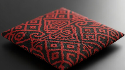 A square cushion with an intricate red and black pattern png