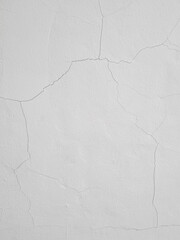Background of hairline crack on white painted concrete wall. Fine cracks on the wall are caused by temperature changes, material shrinkage, structural movement, or poor quality building materials.