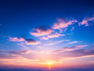 Breathtaking sunset illuminates sky with vibrant colors and soft clouds