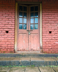 Rustic Wooden Door on Red Brick Wall