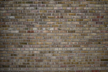 Dark colored brick wall in the evening time.