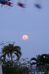 Reddish Full Moon: A Veiled and Ethereal Celestial Wonder