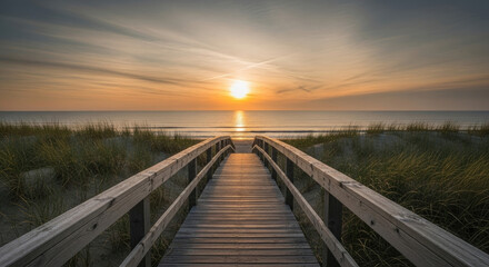 Fototapeta premium Wooden boardwalk leading to a serene beach at sunrise