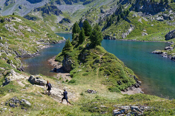 LA PRA, FRANCE, July 10, 2025 : Hiking along the Lac Longet in Belledonne mountain range, on the...