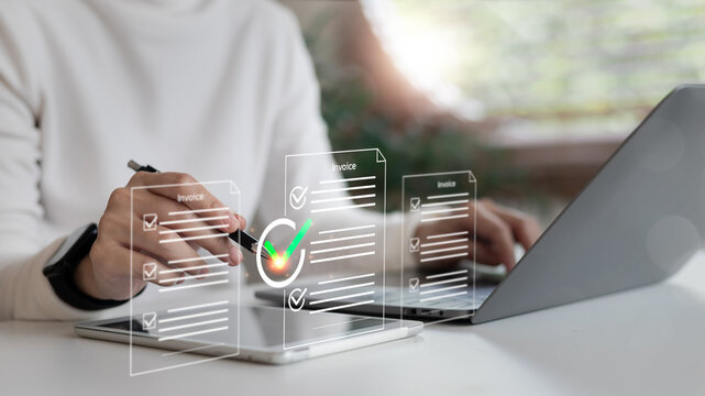 Businesswoman approving digital invoice on tablet and laptop with financial document icons. Concept of paperless billing, e-invoice management, and online finance workflow.