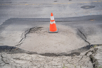 Sinkhole on a road with Traffic Cone