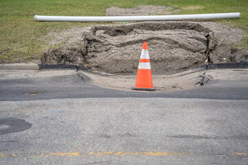 Sinkhole on a road with Traffic Cone