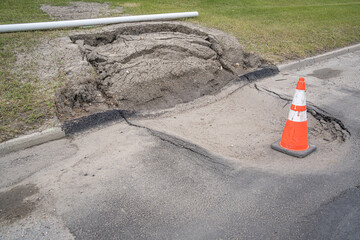 Sinkhole on a road with Traffic Cone
