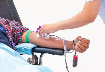 Healthcare professional assisting a donor during blood donation. Symbol of compassion, medical...