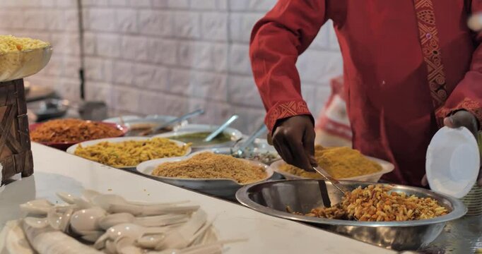 Indian caterers preparing delicious chat, panipuri, bhel, and patis at a festive event, showcasing vibrant flavors and traditional street food culture