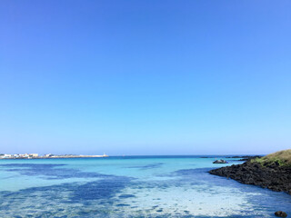 Clear Blue Sea and Sky with Rocky Coastline