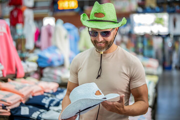 Man shopping fashion hat. Stylish man in boutique. Mature man choosing hat. Male accessories store....