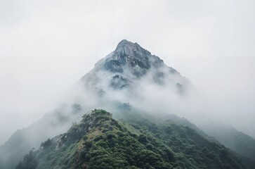 Mystical Mountain Peak Enveloped in Foggy Clouds