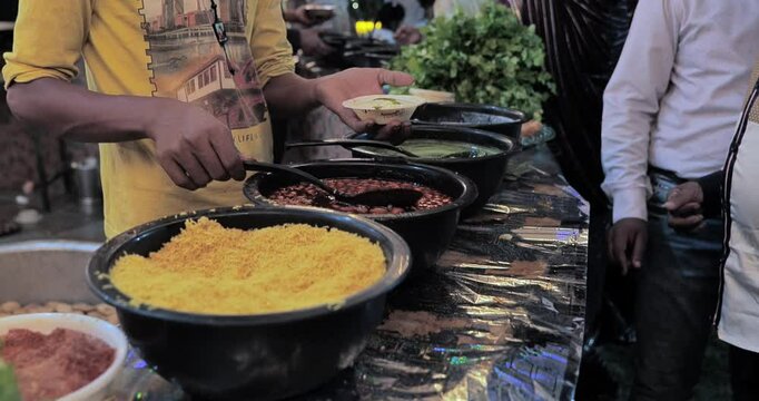 Indian caterers preparing delicious chat, panipuri, and patis at a festive event, showcasing vibrant flavors and traditional street food culture