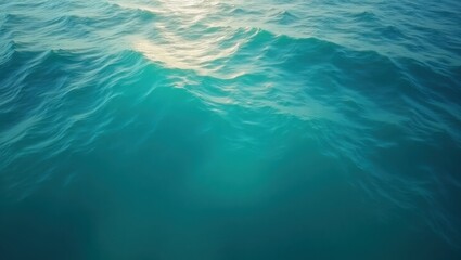 Obraz premium Turquoise ocean surface with sunlight reflecting off gentle waves creating a serene water scene