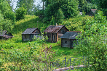 Small old bathhouses on the river bank in a Russian village.