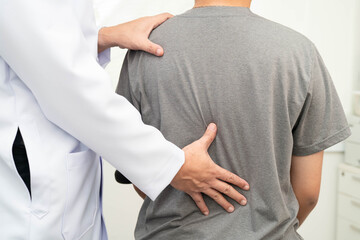 Physical therapy, Asian therapist doctor treat perform pain young man in hospital.
