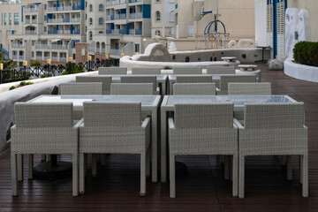 tables and chairs at the outdoor cafe in the hotel