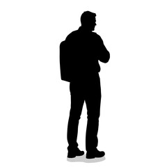 Fototapeta premium Silhouette of man standing with backpack and hands crossed 