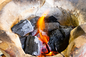 Glowing Charcoal Embers with Flames  and  Fire Heat Background for BBQ concept idea