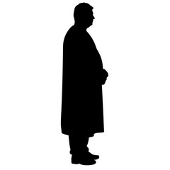 Silhouette of a man standing in profile with hands clasped  